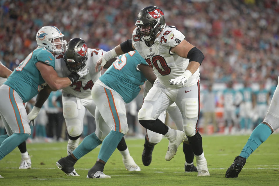 Tampa Bay Buccaneers offensive tackle Robert Hainsey (70) blocks for quarterback Kyle Trask against the Miami Dolphins during the first half of an NFL preseason football game Saturday, Aug. 13, 2022, in Tampa, Fla. (AP Photo/)