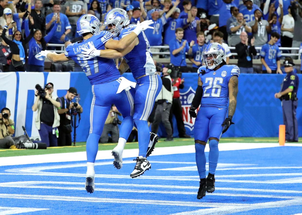 Lions tight ends Sam LaPorta (87), Brock Wright (89) and running back Jahmyr Gibbs (26) celebrate LaPorta's touchdown Sept. 24 vs. the Falcons at Ford Field.