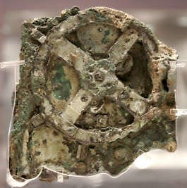 A fragment of the 2,100-year-old Antikythera Mechanism, believed to be the earliest surviving mechanical computing device, is seen in 2021 at the National Archaeological Museum in Athens, Greece. The bronze system of cogs and wheels was found in a Roman-era shipwreck off southern Greece in 1901. The ship was laden with treasures being sent to Rome to honor Julius Caesar.