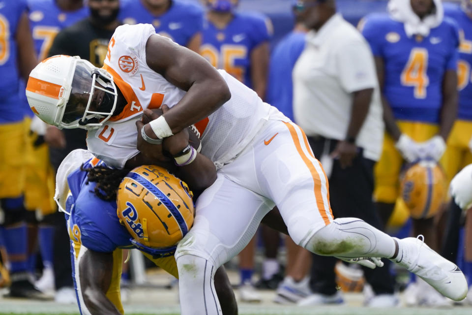 Pittsburgh defensive back Brandon Hill (9) tackles Tennessee quarterback Hendon Hooker (5) as he scrambles during the first half of an NCAA college football game, Saturday, Sept. 10, 2022, in Pittsburgh. (AP Photo/Keith Srakocic)