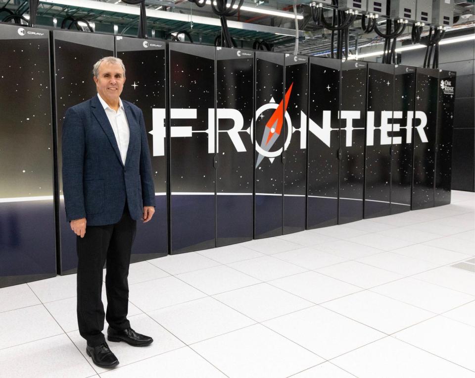 Nobel laureate Eric Betzig poses in front of Frontier, the world’s fastest supercomputer, at Oak Ridge National Laboratory.