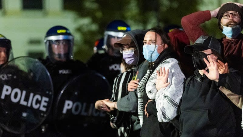 Demonstrators lock arms in front of a police line at the President’s Circle in support of Palestine at the University of Utah in Salt Lake City on Monday, April 29, 2024.