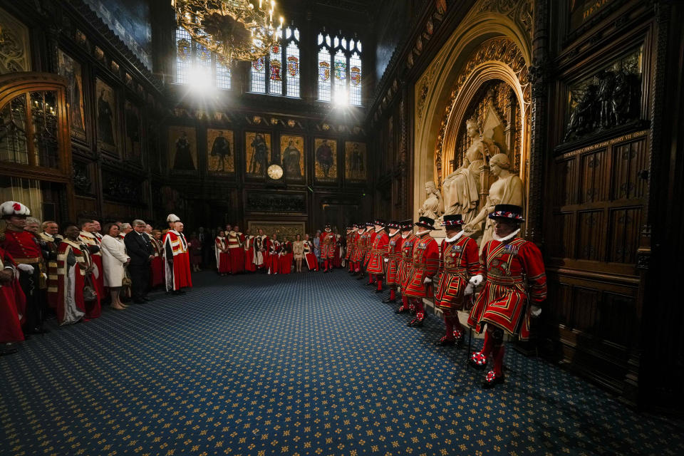 Yeomen Warders perform the ceremonial search of the Palace of Westminster prior to the State Opening of Parliament in London, Tuesday, May 10, 2022. Buckingham Palace said Queen Elizabeth II will not attend the opening of Parliament on Tuesday amid ongoing mobility issues. (AP Photo/Alastair Grant, Pool)