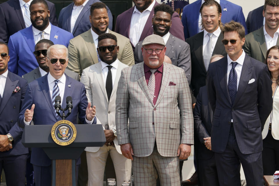 President Joe Biden, surrounded by members of the Tampa Bay Buccaneers, speaks during a ceremony on the South Lawn of the White House, in Washington, Tuesday, July 20, 2021, where the president honored the Super Bowl Champion Tampa Bay Buccaneers for their Super Bowl LV victory. Tampa Bay Buccaneers head coach Bruce Arians, center, and Tampa Bay Buccaneers quarterback Tom Brady, right, look on. (AP Photo/Andrew Harnik)