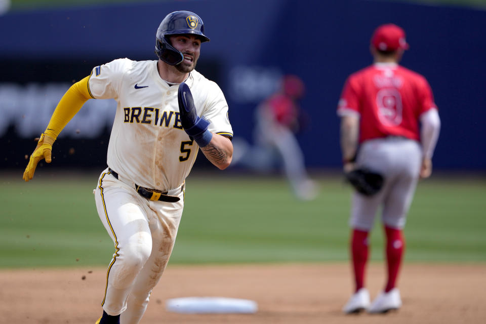 Milwaukee Brewers' Garrett Mitchell rounds third to score on a double hit by Christian Yelich during the first inning of a spring training baseball game against the Los Angeles Angels, Monday, March 18, 2024, in Phoenix. (AP Photo/Matt York)