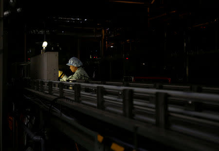 FILE PHOTO - An employee works at a beer production line at a factory in Toride, Ibaraki Prefecture, Japan July 14, 2017. REUTERS/Kim Kyung-Hoon/File Photo