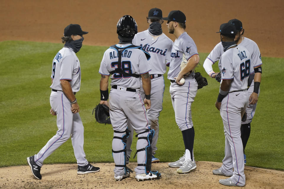 Miami Marlins manager Don Mattingly, left, relieves starting pitcher Daniel Castano, third from right, in the fifth inning during the first baseball game of a doubleheader against the New York Mets, Tuesday, Aug. 25, 2020, in New York. (AP Photo/John Minchillo)