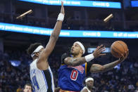 Golden State Warriors guard Gary Payton II (0) shoots against Orlando Magic center Wendell Carter Jr. during the first half of an NBA basketball game in San Francisco, Monday, Dec. 6, 2021. (AP Photo/Jeff Chiu)