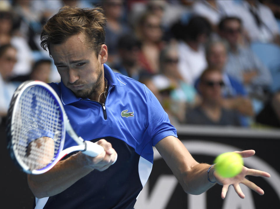 FILE - In this Jan. 27, 2020, file photo, Russia's Daniil Medvedev makes a forehand return to Switzerland's Stan Wawrinka during their fourth round singles match at the Australian Open tennis championship in Melbourne, Australia. Medvedev is scheduled to play in the U.S. Open, scheduled for Aug. 31-Sept. 13, 2020.(AP Photo/Andy Brownbill, File)