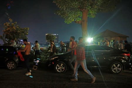 Small groups of protesters shouting anti-government slogans and run from tear gas fired by riot police near Tahrir Square in Cairo