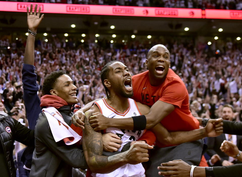 Toronto Raptors forward Kawhi Leonard (2) celebrates his last-second basket with teammates at the end of the second half of an NBA Eastern Conference semifinal basketball game against the Philadelphia 76ers in Toronto on Sunday, May 12, 2019. (Frank Gunn/The Canadian Press via AP)