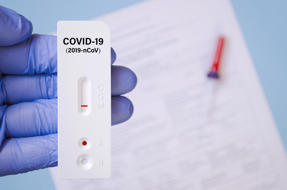 Positive test result by using rapid test for COVID-19, quick fast antibody point of care testing.