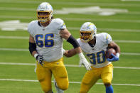 CORRECTS BY REMOVING REFERENCE TO A TOUCHDOWN - Los Angeles Chargers running back Austin Ekeler, right, runs behind center Dan Feeney (66) against the Carolina Panthers during the first half of an NFL football game Sunday, Sept. 27, 2020, in Inglewood, Calif. (AP Photo/Ashley Landis)