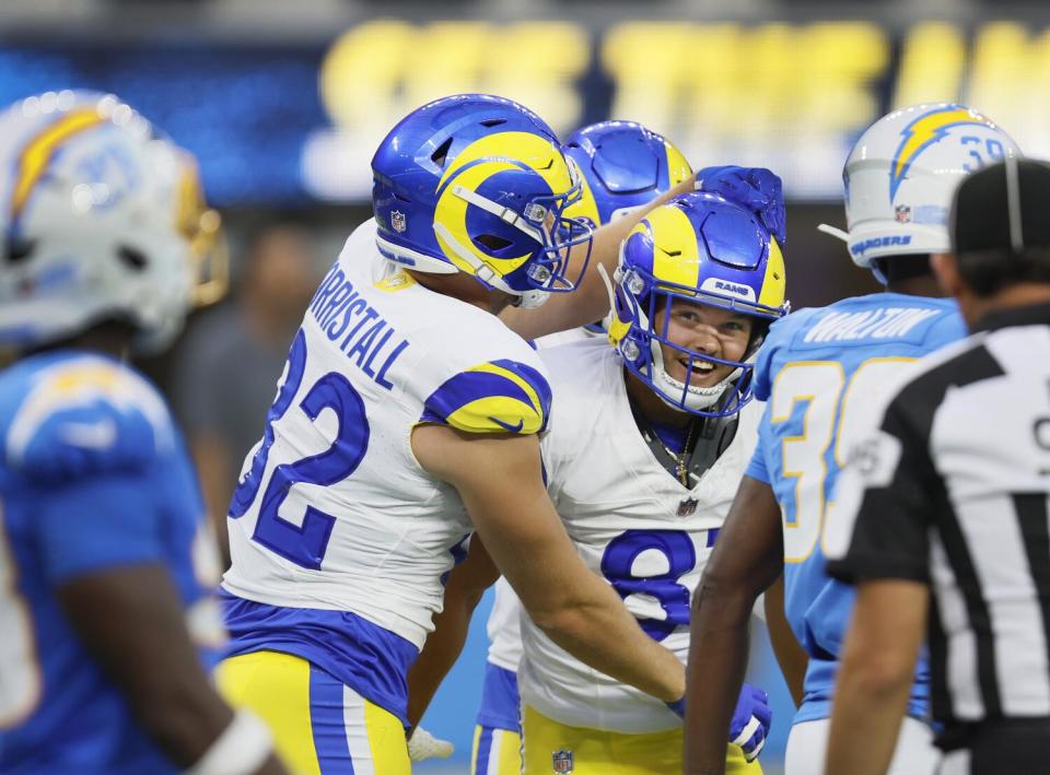 Rams wide receiver JJ Laap, right, celebrates with a teammate after catching a 47-yard touchdown pass from Stetson Bennett.