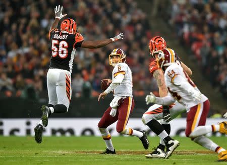 Oct 30, 2016; London, United Kingdom; Washington Redskins quarterback Kirk Cousins (8) throws downfield under pressure from Cincinnati Bengals linebacker Karlos Dansby (56) during the third quarter at Wembley Stadium. Mandatory Credit: Steve Flynn-USA TODAY Sports