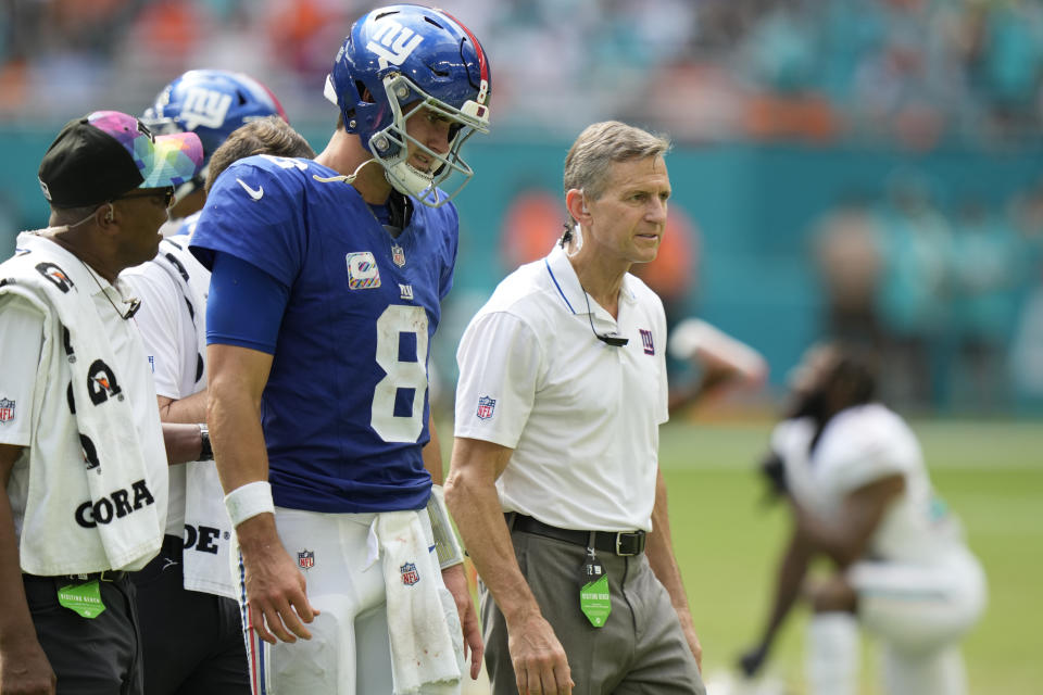 New York Giants quarterback Daniel Jones (8) is escorted off the field during the second half of an NFL football game against the Miami Dolphins, Sunday, Oct. 8, 2023, in Miami Gardens, Fla. (AP Photo/Wilfredo Lee)