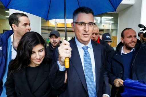 Former interior minister Gideon Saar (C), accompanied by his wife Geula Even Saar, voted in Tel Aviv in the Likud leadership challenge in which he is facing off against long-time party head Netanyahu