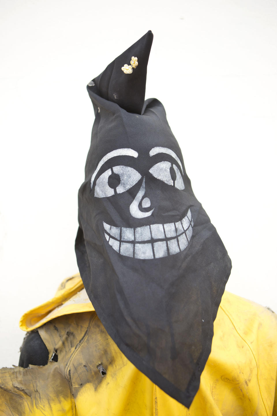 In this April 18, 2014 photo, a youth in a mask representing "Judas" poses for a picture during a break while participating in "Los Encadenados," or The Chained Ones procession on Good Friday during Holy Week in Masatepe, Nicaragua. The youth played the part of Judas who is carried away in chains. Participants attach long chains and then drag him around, sometimes symbolically kicking and beating him, as punishment for betraying Jesus Christ. (AP Photo/Esteban Felix)