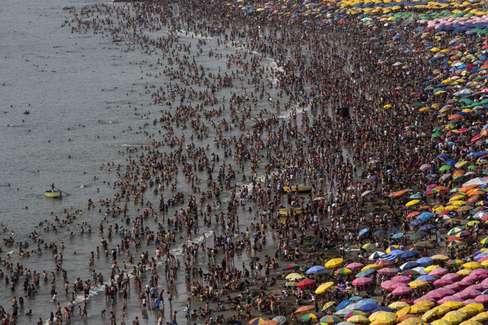 This Feb. 16, 2020 photo shows the the Agua Dulce public beach packed with thousands of beachgoers in Lima, Peru. On some weekends during the Southern Hemisphere summer, which runs from December until March, as many as 40,000 people a day visit the half-mile-long (kilometer-long) strip of Agua Dulce. (AP Photo/Rodrigo Abd)