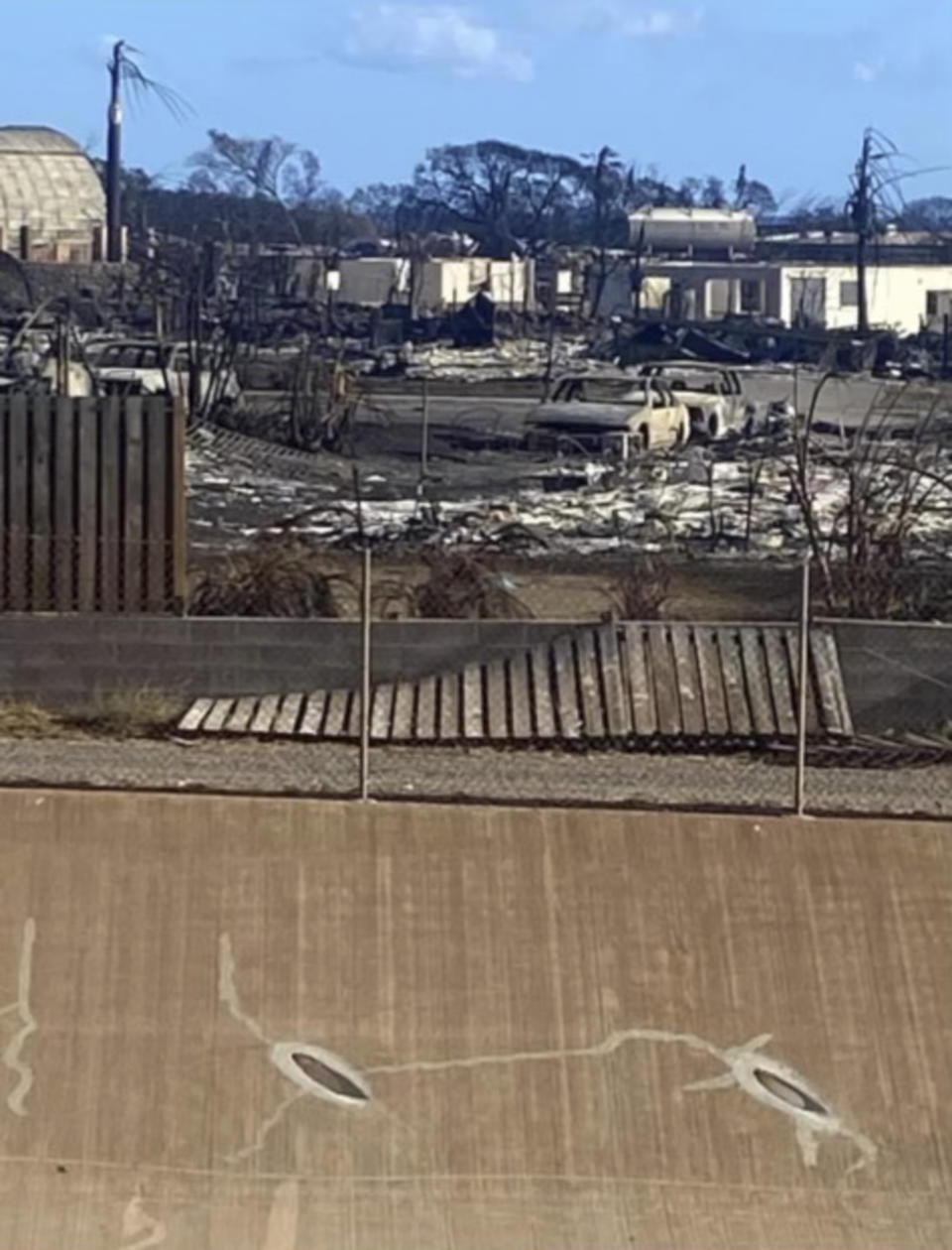 This image provided by Amy Chadwick shows her neighborhood after a wildfire destroyed her home in Lahaina, on the Hawaiian island of Maui. Chadwick moved to Florida where she could stretch her homeowners insurance dollars. She's worried Maui's exorbitant rental prices, which she blames in part on vacation rentals hogging up limited housing supply, will hollow out her tight-knit town by similarly forcing others to leave. (Amy Chadwick via AP)