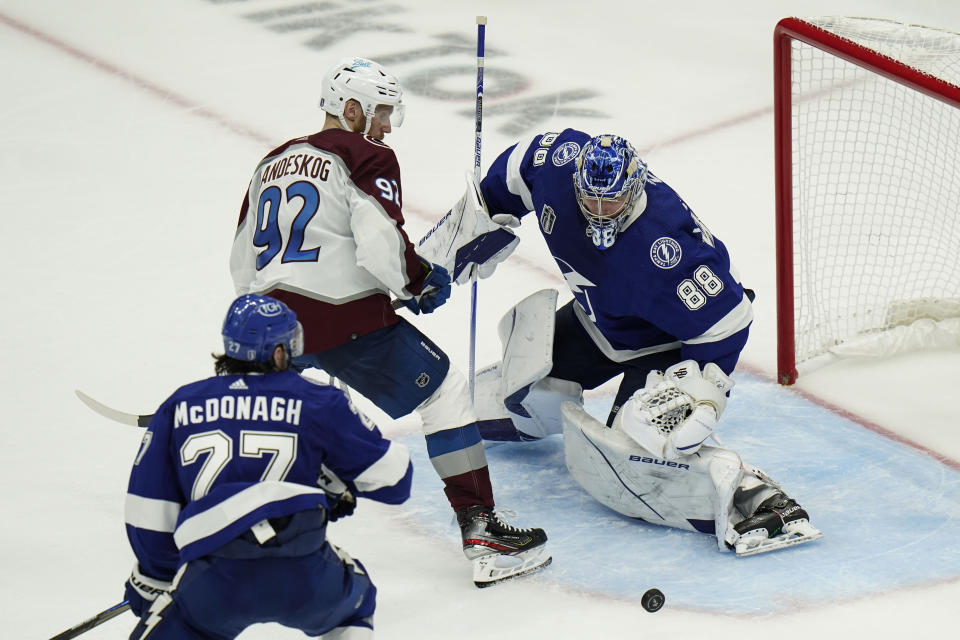 Tampa Bay Lightning goaltender Andrei Vasilevskiy (88) stops a shot by Colorado Avalanche left wing Gabriel Landeskog (92) during the third period of Game 3 of the NHL hockey Stanley Cup Final on Monday, June 20, 2022, in Tampa, Fla. (AP Photo/Chris O'Meara)