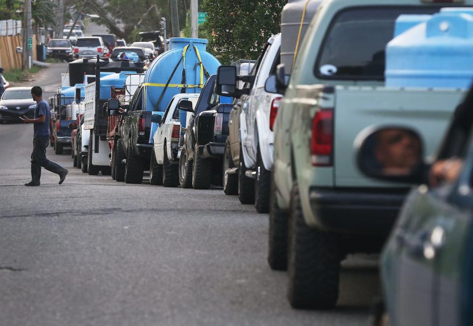 People wait in their vehicles to collect water in San Pedro, Puerto Rico, on Oct. 19, 2017, nearly one month after Hurricane Maria. <a href="https://www.gettyimages.com/detail/news-photo/people-wait-in-their-cars-in-line-to-collect-water-nearly-news-photo/863242170" rel="nofollow noopener" target="_blank" data-ylk="slk:Mario Tama/Getty Images;elm:context_link;itc:0;sec:content-canvas" class="link ">Mario Tama/Getty Images</a>