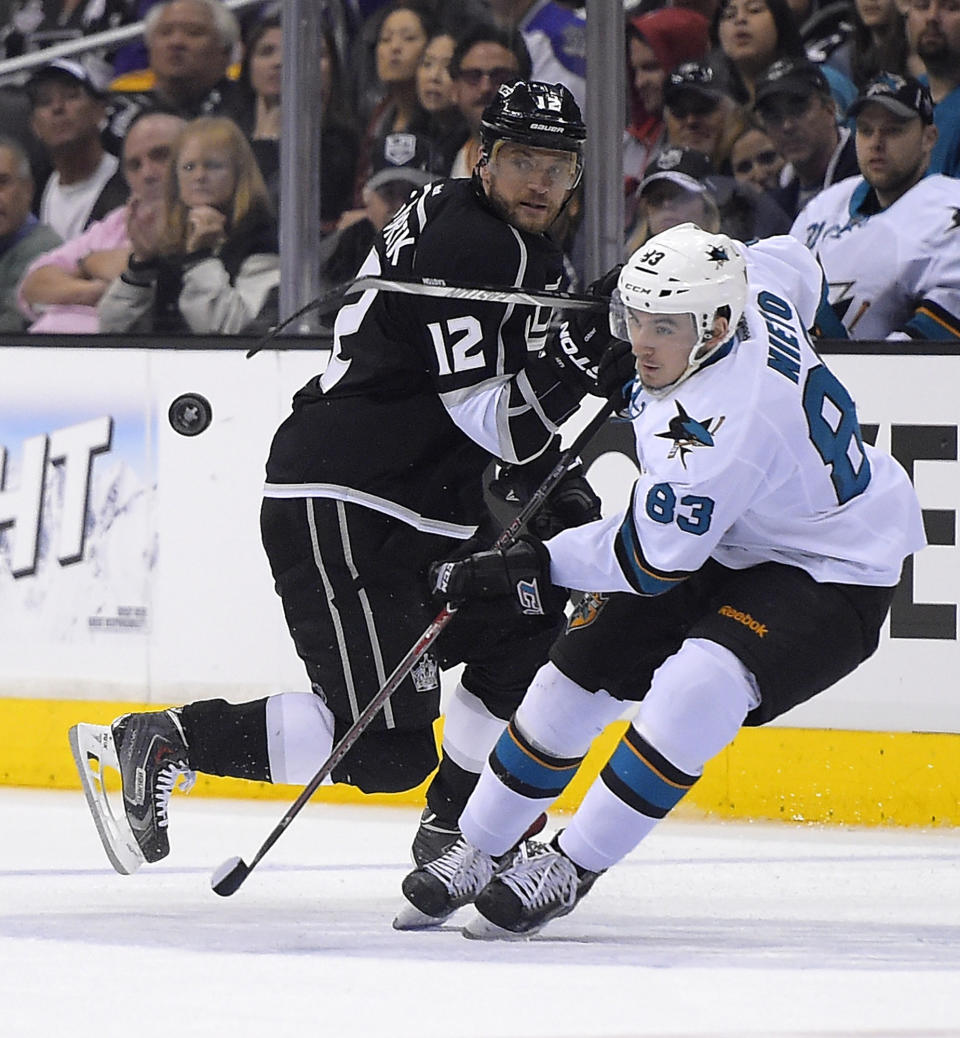 Los Angeles Kings right wing Marian Gaborik, left, of Slovakia, and San Jose Sharks left wing Matt Nieto watch the puck during the second period in Game 6 of an NHL hockey first-round playoff series, Monday, April 28, 2014, in Los Angeles. (AP Photo)