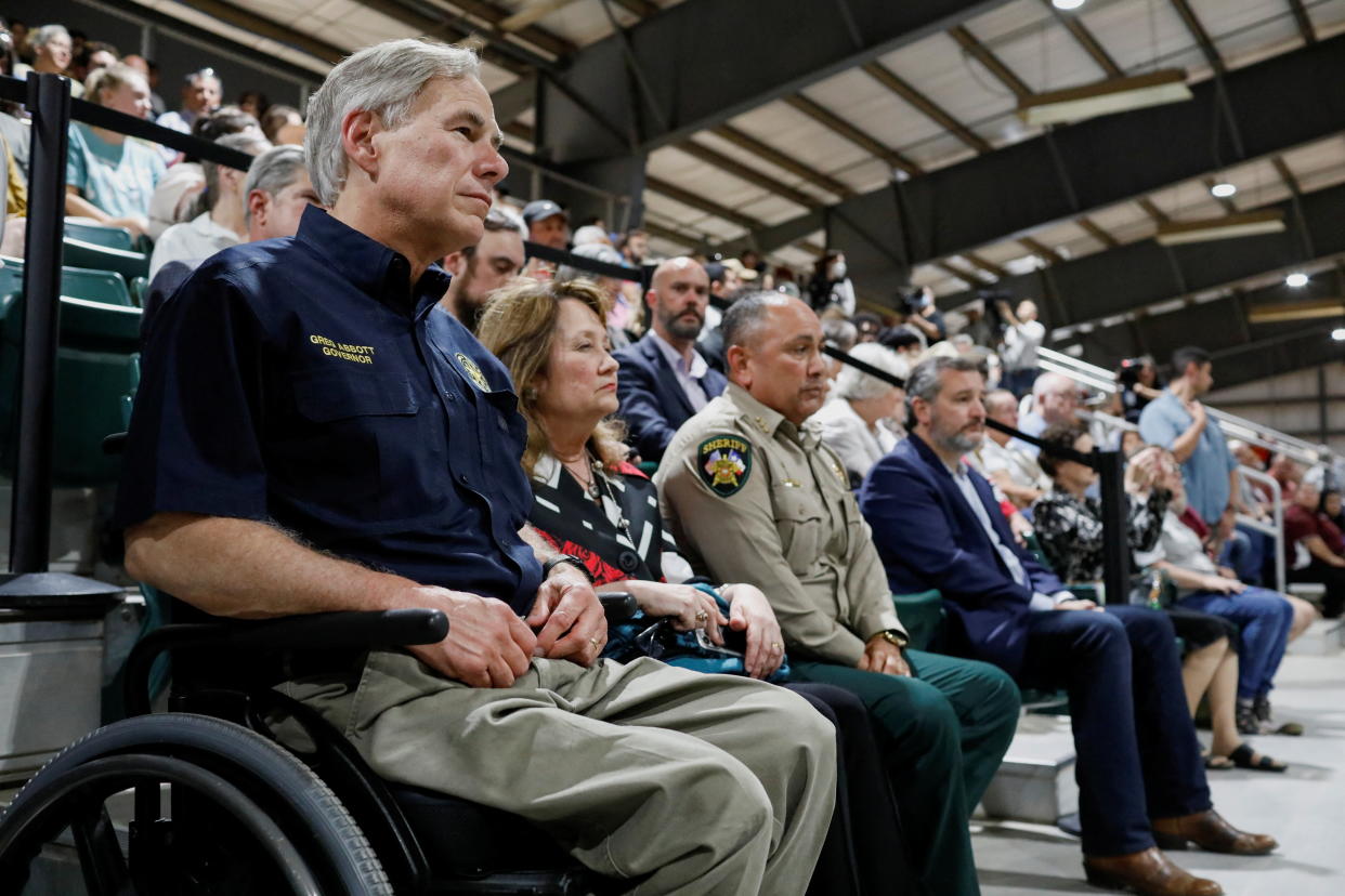 Texas Governor Greg Abbott (left) attends a vigil a day after a gunman killed 19 children and two teachers at Robb Elementary School, at Uvalde County Fairplex Arena, in Uvalde, Texas, May 25, 2022. (Reuters)