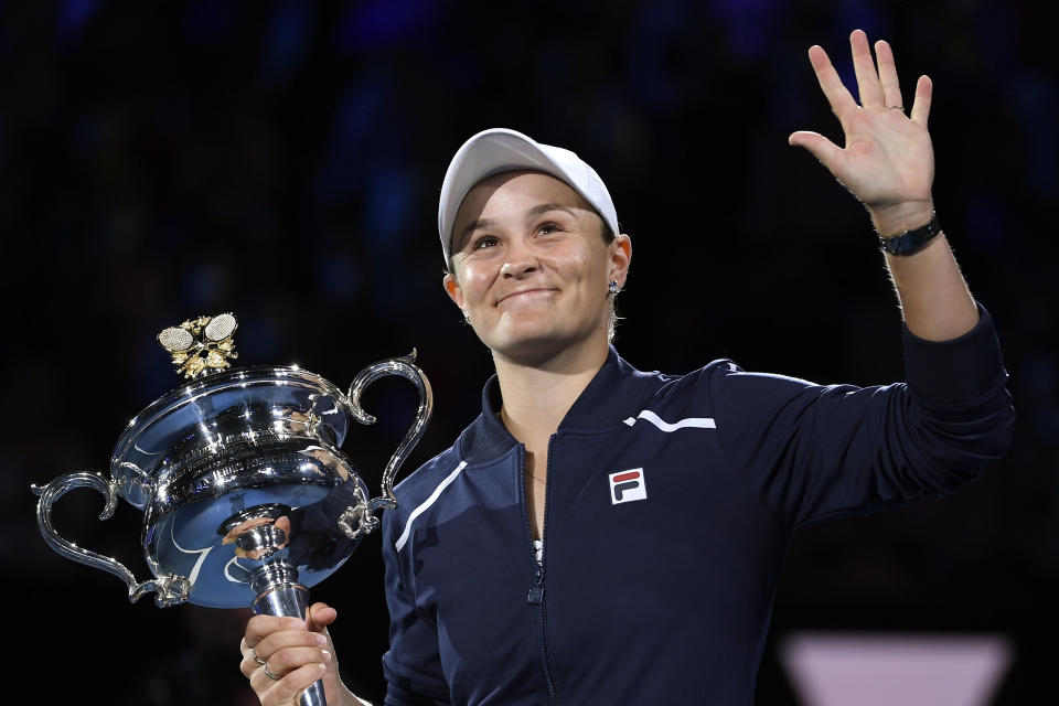 FILE - Ash Barty of Australia waves as she holds the Daphne Akhurst Memorial Cup after defeating Danielle Collins of the U.S., in the women's singles final at the Australian Open tennis championships in Melbourne, Australia, Saturday, Jan. 29, 2022. Shocking everyone except a few close friends and family, Barty announced her retirement in March. (AP Photo/Andy Brownbill, File)