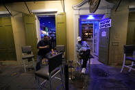 Patrons resume their socializing at Cuban Cigar Bar in the French Quarter in New Orleans, after power was restored Wednesday, Oct. 28, 2020. Hurricane Zeta passed through today leaving much of the city and metro area without power. (AP Photo/Gerald Herbert)