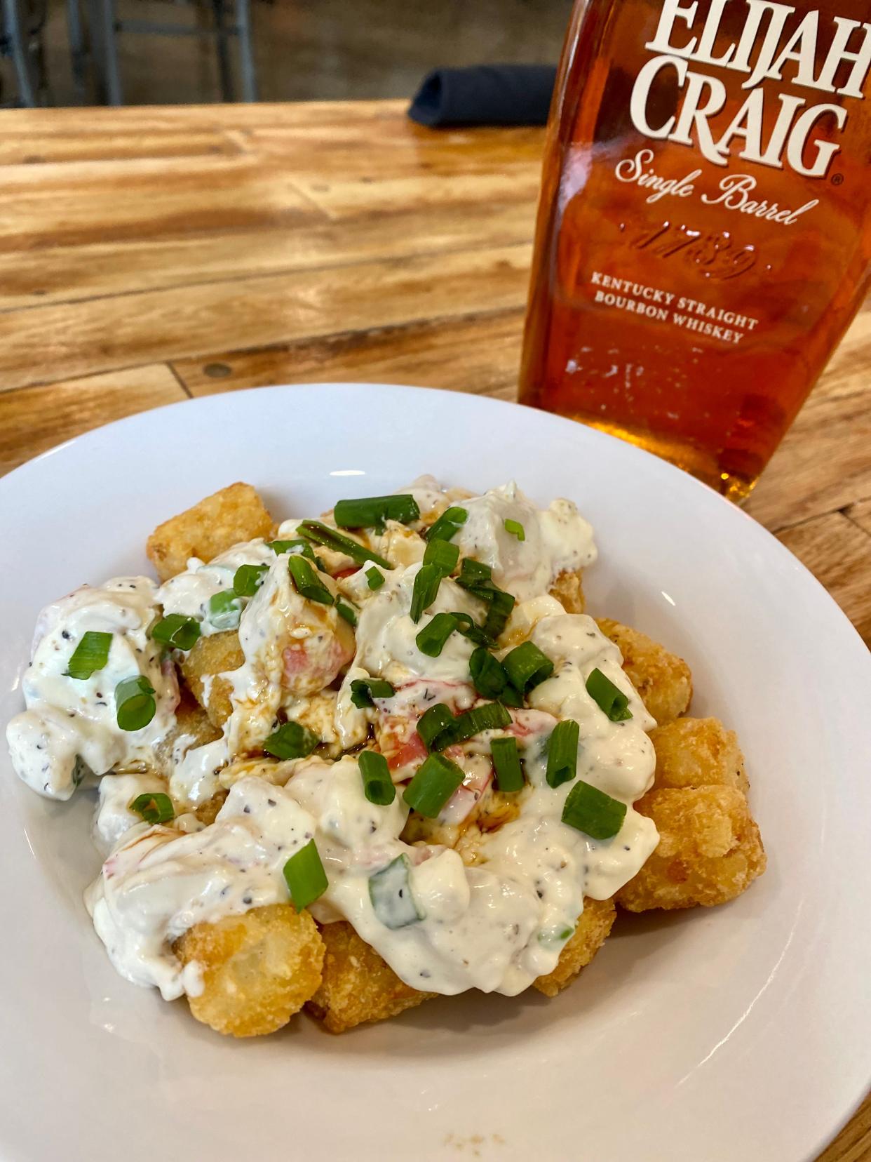 A special that you'll sometimes find offered at the Cap & Cork - Tots smothered in a crab rangoon style topping with cream cheese, finished with scallions.
