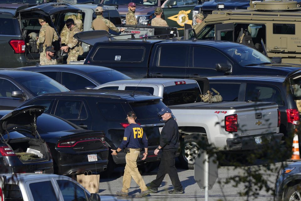 FILE - Law enforcement personnel are staged in a school parking lot during a manhunt for Robert Card in the aftermath of a mass shooting in Lewiston, Maine, Oct. 27, 2023. Months after a deadly mass shooting in Maine, backers and detractors held an hourslong debate over a so-called red flag bill. The measure discussed on Friday, April 5, 2024, would let family members petition a judge to remove guns from someone experiencing a psychiatric crisis. (AP Photo/Matt Rourke, File)