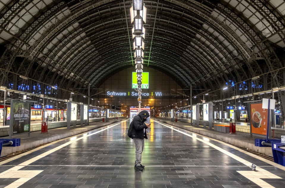 A man checks his mobile phone in the central train station in Frankfurt, Germany, Friday, Dec. 8, 2023, when train drivers of the GDL union went on a 24-hour-strike. (AP Photo/Michael Probst)