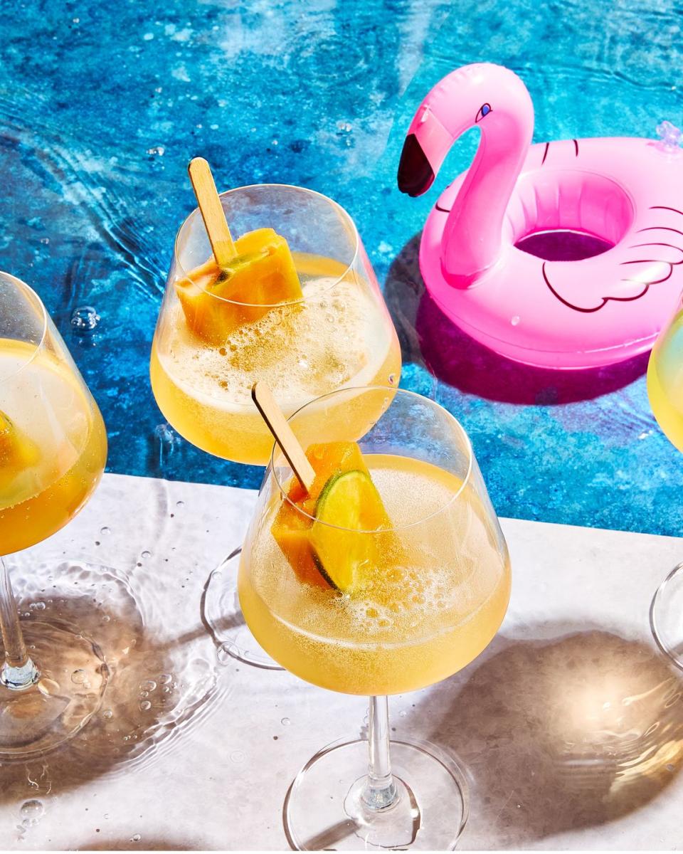 spritz with orange popsicles in them by a pool