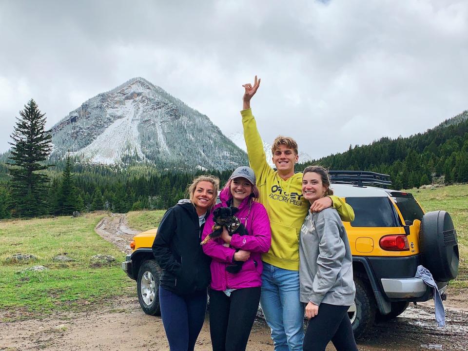 Four people in front of an FJ Cruiser
