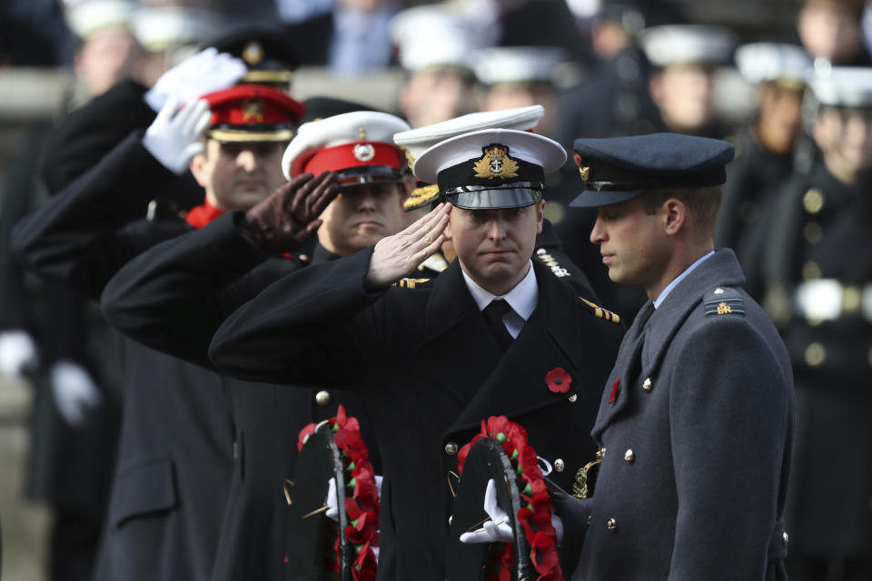 Britain's Prince William lays a wreath during the remembrance service at the Cenotaph memorial in Whitehall, central London, on the 100th anniversary of the signing of the Armistice which marked the end of the First World War, in London, Sunday, Nov. 11, 2018. (Andrew Matthews/ PA via AP)