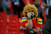 <p>Colombia fan looks dejected after losing the penalty shootout. REUTERS/Carl Recine </p>