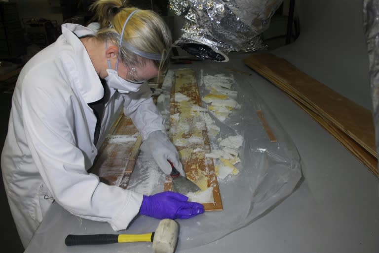 Crystal methamphetamine is removed from planks of wood at a warehouse in Nunawading, east of Melbourne, Australia, where it was hidden in 70 boxes of floorboards shipped from China