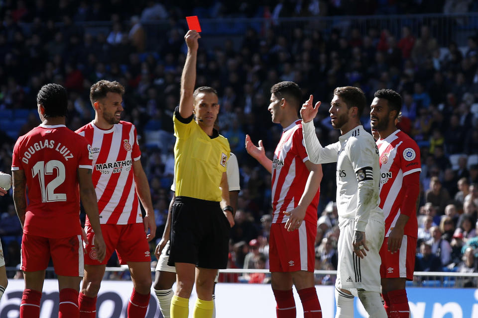 Real Madrid's Sergio Ramos, second right, receives a red card during a La Liga soccer match between Real Madrid and Girona at the Bernabeu stadium in Madrid, Spain, Sunday, Feb. 17, 2019. (AP Photo/Andrea Comas)