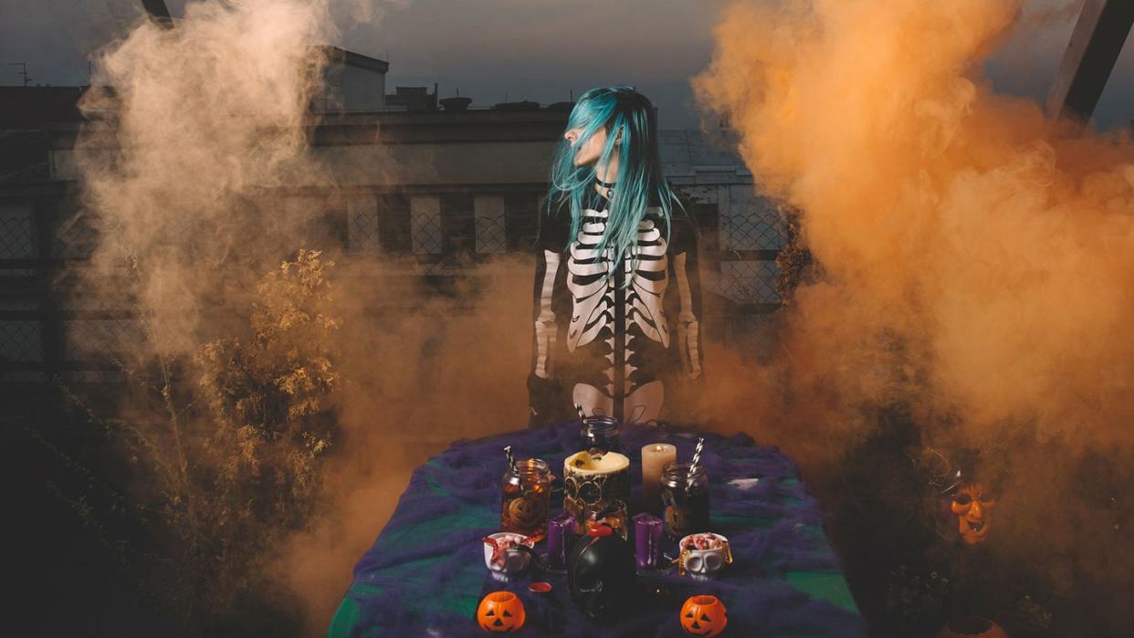 girl in skeleton costume at a foggy halloween party