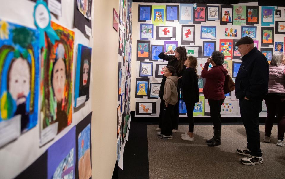 Museum goers look at some of more than 1,000 pieces of artwork during the opening reception for the 93rd annual Robert T. McKee Student Art Show at the Haggin Museum in Stockton on Feb. 3, 2024. More than 1,000 pieces of art from students from all around the county are displayed in the show which runs at the museum until March 17.