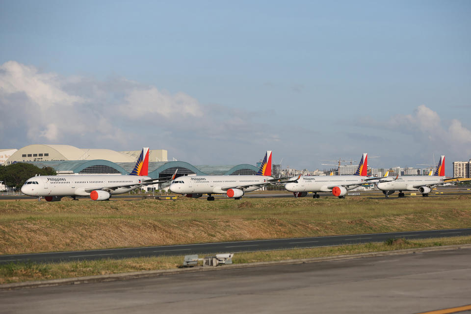 FILES PHOTO: This file photo taken on April 19, 2020 shows passenger planes from carrier Philippine Airlines parked on the tarmac of Manila's international airport as air travel to and from the Philippines was suspended after the government implemented a lockdown in its efforts to contain the spread of the COVID-19 coronavirus. Philippine Airlines said late on October 5, 2020 that the flag carrier will cut a third of its workforce by yearend as it reels from the fallout of the coronavirus pandemic. (Photo: STR/AFP via Getty Images)