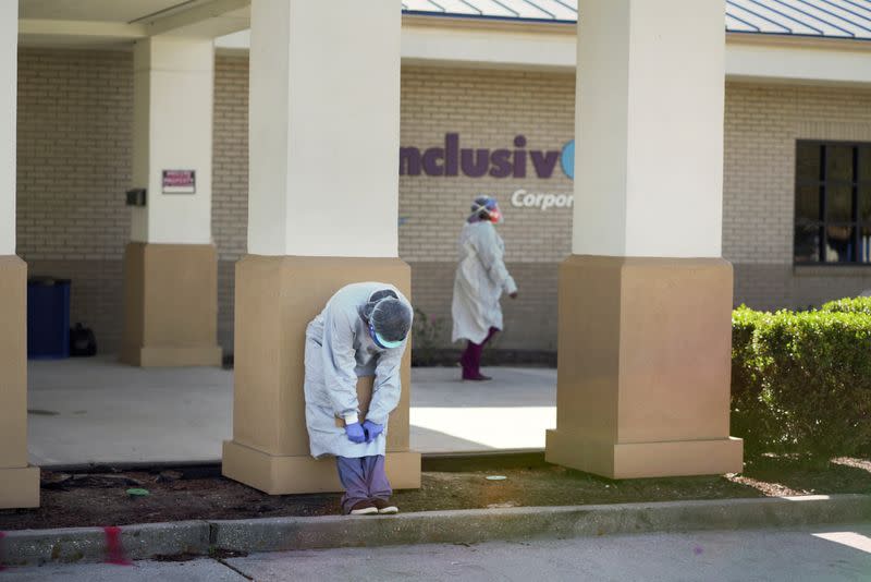 FILE PHOTO: A worker takes a break as the Moderna coronavirus disease (COVID-19) vaccination is distributed during a drive through event where one hundred vaccinations were to be administered at InclusivCare in Avondale