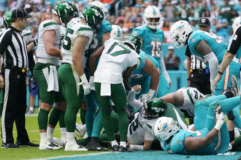 New York Jets quarterback Zach Wilson (2) scores a touchdown during the first half of an NFL football game against the Miami Dolphins, Sunday, Dec. 19, 2021, in Miami Gardens, Fla. (AP Photo/Lynne Sladky)