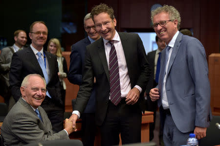 (L-R) Germany's Finance Minister Wolfgang Schauble chats with Eurogroup President Jeroen Dijsselbloem and Luxembourg's Finance Minister Pierre Gramegna during a Euro zone finance ministers meeting, to discuss whether Greece has passed sufficient reforms to unblock new loans and how international lenders might grant Athens debt relief, in Brussels, Belgium, May 24, 2016. REUTERS/Eric Vidal