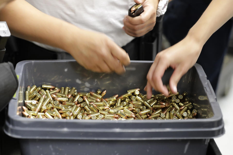 FILE - In this July 16, 2019, file photo, officers taking part in training load gun clips with ammunition at the Washington State Criminal Justice Training Commission in Burien, Wash. The COVID-19 pandemic coupled with record sales of firearms have created a shortage of ammunition in the United States that has impacting competition and recreational shooters, hunters, people seeking personal protection and law enforcement agencies. (AP Photo/Ted S. Warren, File)