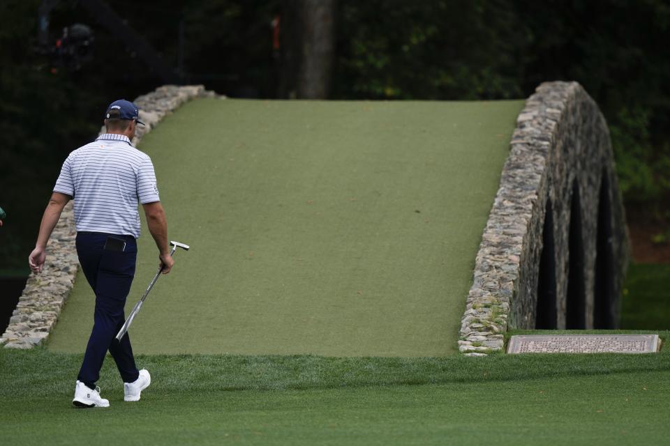Bryson DeChambeau walks over the bridge on on the 12th hole during the first round at the Masters golf tournament at Augusta National Golf Club Thursday, April 11, 2024, in Augusta, Ga. (AP Photo/Charlie Riedel)
