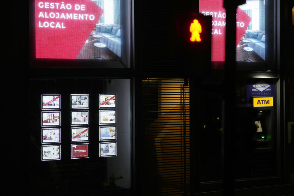 A screen on display at a real estate agency announcing "Short-term rental management" in Lisbon, Sunday, March 12, 2023. Portugal’s center-left Socialist government is set to approve a package of measures to address the country's housing crisis. A growing number of people are being priced out of the property market by rising rents, surging house prices and climbing mortgage rates. (AP Photo/Armando Franca)