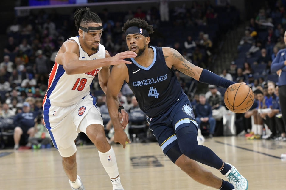 Memphis Grizzlies guard Jordan Goodwin (4) drives against Detroit Pistons forward Tosan Evbuomwan (18) during the second half of an NBA basketball game Friday, April 5, 2024, in Memphis, Tenn. (AP Photo/Brandon Dill)