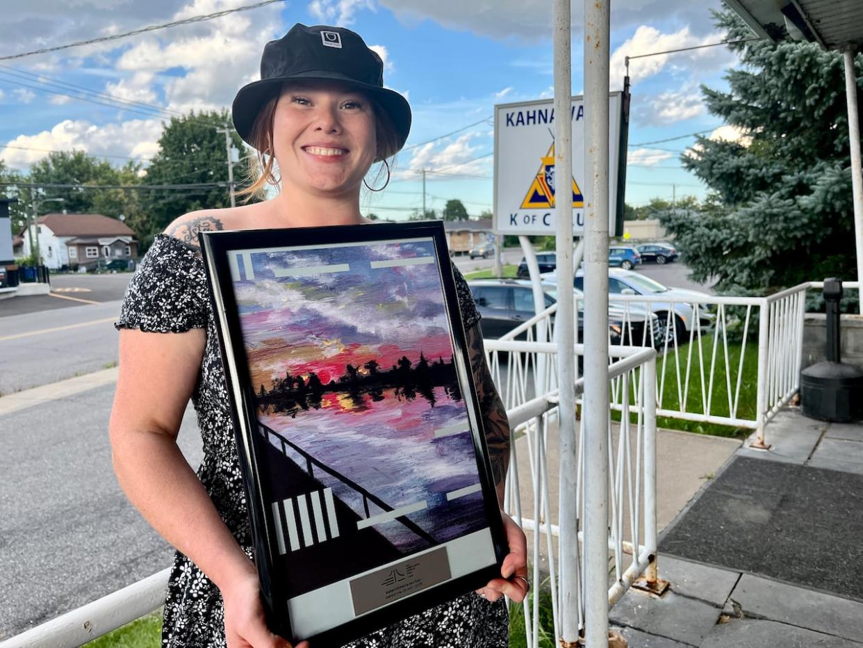 Wakenhiióhstha Montour's painting Behind the Church is one of 11 works featured on banners installed on Honoré Mercier Bridge.  (Ka’nhehsí:io Deer/CBC - image credit)